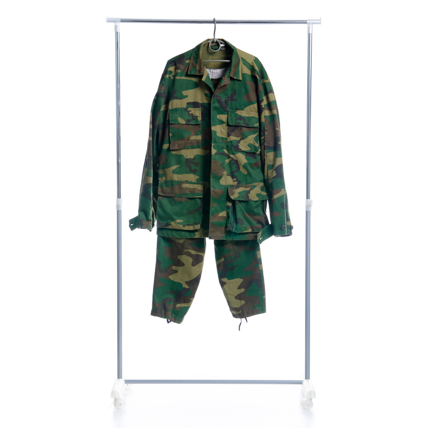 Camouflage military clothing on hanger rack